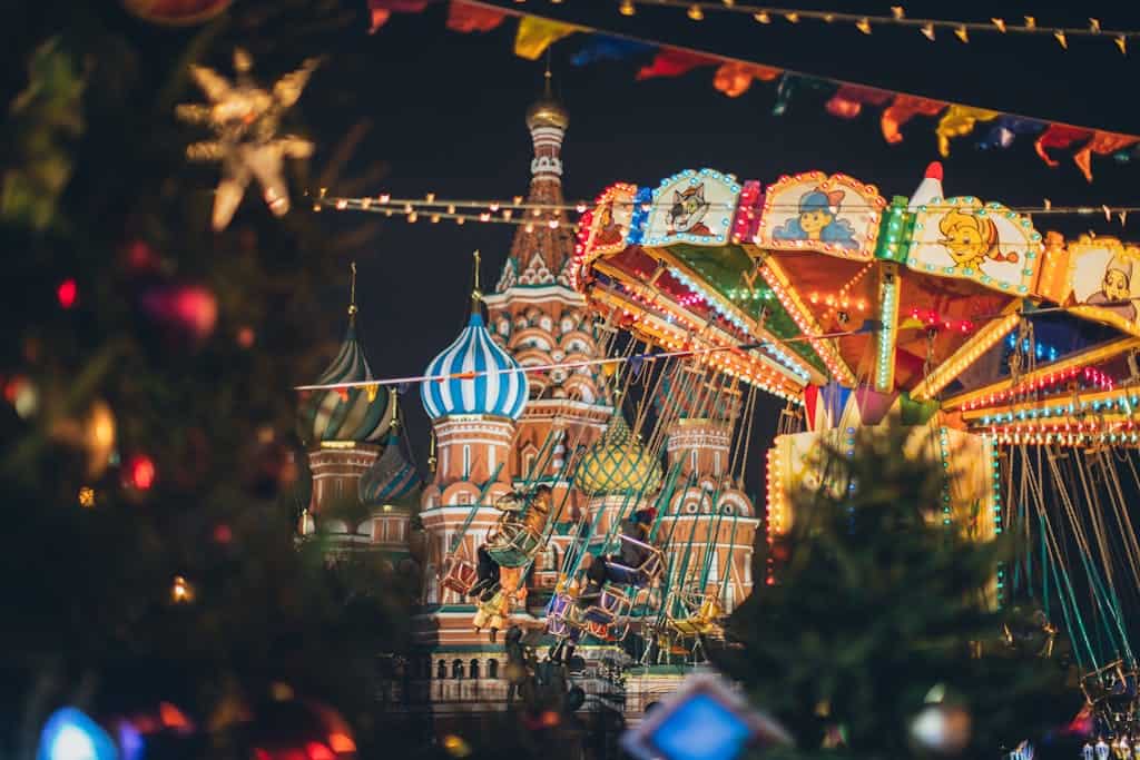 Colorful carousel against Cathedral on Red Square at New Year night
